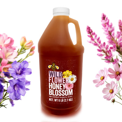 A gallon full of wildflower honey surrounded by wildflowers