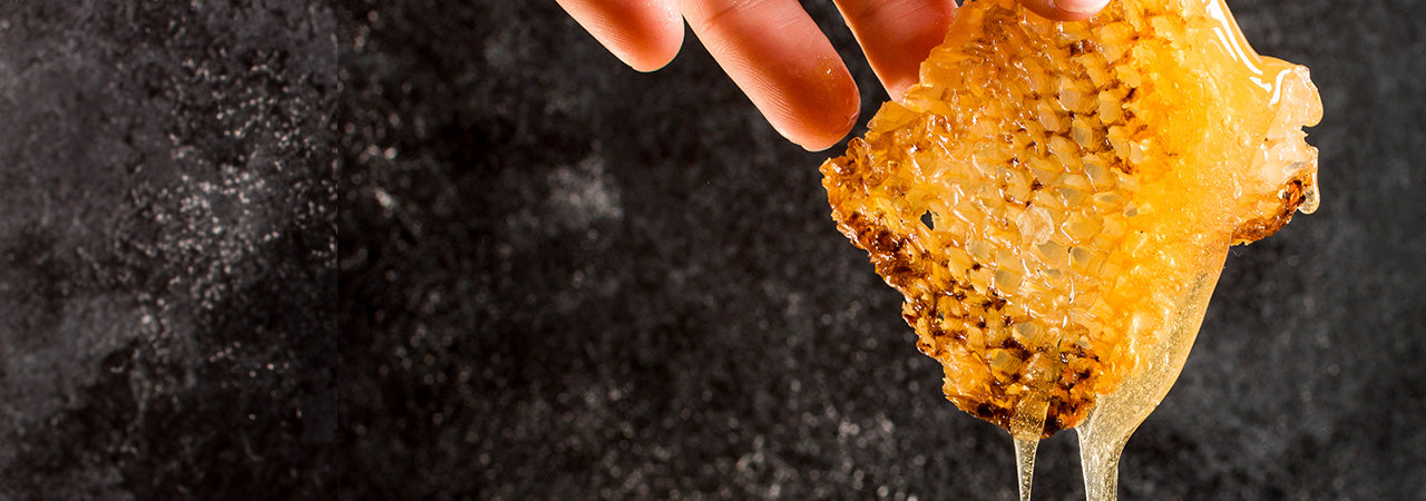 Crystallized honey dripping from a honeycomb