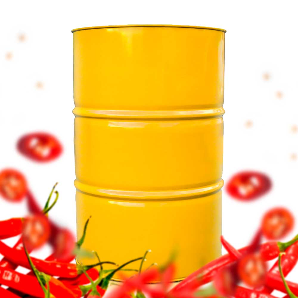 A drum, filled with hot honey, surrounded by cayenne peppers