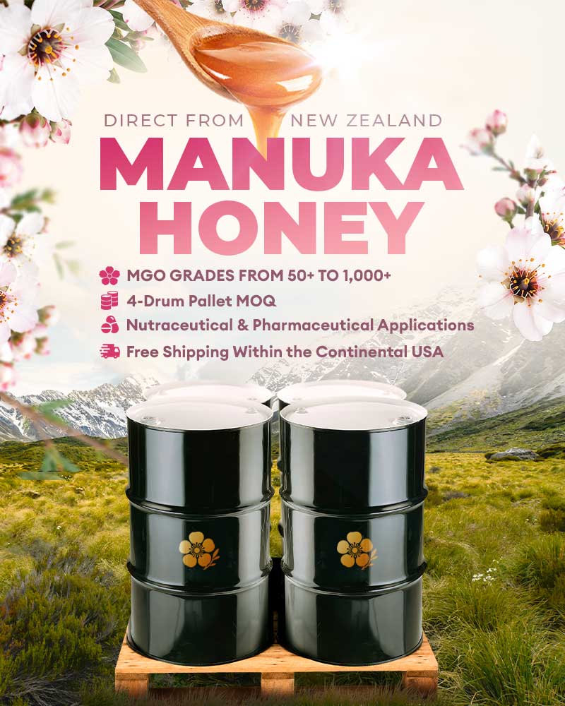 Promotional banner for New Zealand Manuka honey featuring honey dripping from a wooden spoon, blooming Manuka flowers, and four black honey drums on a pallet set against a mountain landscape. Text highlights MGO grades from 50+ to 1,000+, bulk pallet orders, nutraceutical and pharmaceutical applications, and free shipping within the continental USA.